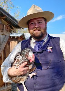 Cody Jolliff holds a heritage chicken at Nash Farm